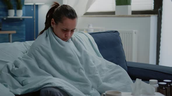 Person with Disease Feeling Cold with Blanket and Pillow on Couch