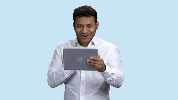 Shocked Man Looking at Digital Tablet