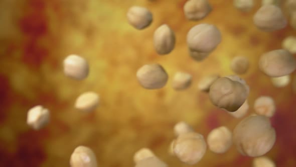 Close Up of Peeled Hazelnuts Falling and Spinning on the Yellow Ochre Background