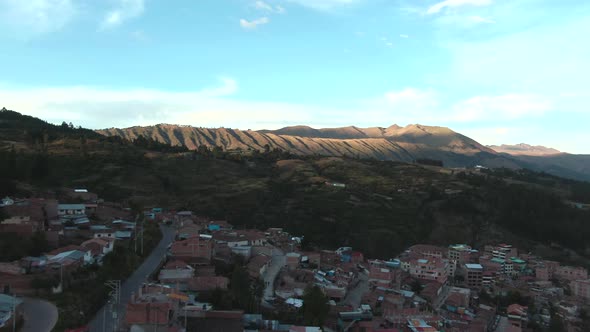 4k daytime aerial drone view over the hill and houses of Alto Los Incas neighbourhood in Cusco, Peru