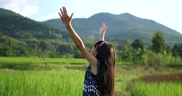 Asian Cute Little Girl Cheering In Rice Field