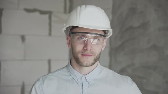 Young engineer-architect looks at the camera  alt