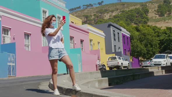 Woman Tourist in Pandemic Shoots on the Phone in Cape Town BoKaap Malay Area Perspective of Cobble