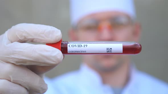 Doctor Holding Test Tube with Blood Sample to Coronavirus