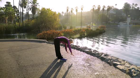 Senior Woman Working Out In The Park