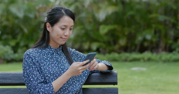 Woman use of mobile phone in the park