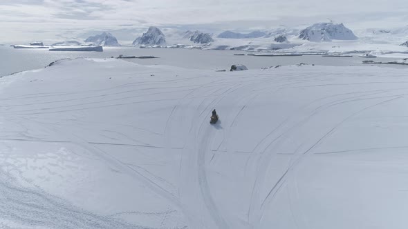 Aerial Flight Over Moving Snowmobile. Antarctica.