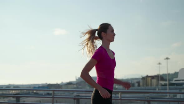 Sport and Healthy Lifestyle of Modern People Young Woman is Running in City in Morning