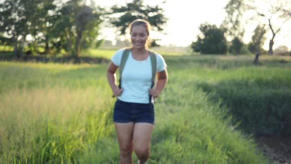 Slow motion, Happy woman hiker trekking on walking in forest