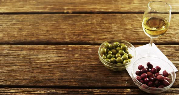 Wine served with green and red olives