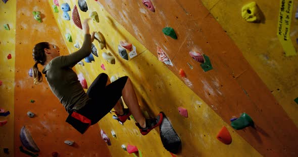 Woman Climbing the Artificial Wall at Bouldering Gym 4k