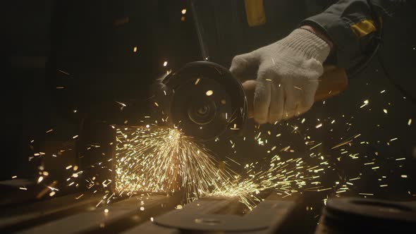 Industrial worker using an angle grinder