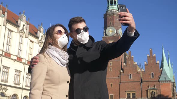 Young couple in masks on city street of Wroclaw, Poland