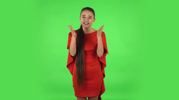 Pretty Young Displeased Woman Is Indignantly Talking To Someone. Green Screen