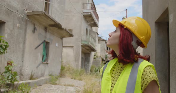 Female engineer looking at the city after the earthquake disaster