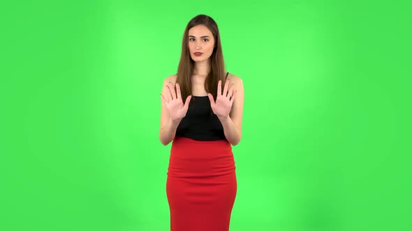 Woman Strictly Gesturing with Hands Shape Meaning Denial Saying NO. Green Screen