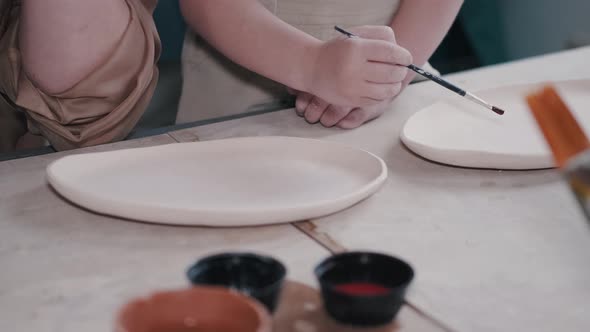 Craftsman Hands Painting a Clay