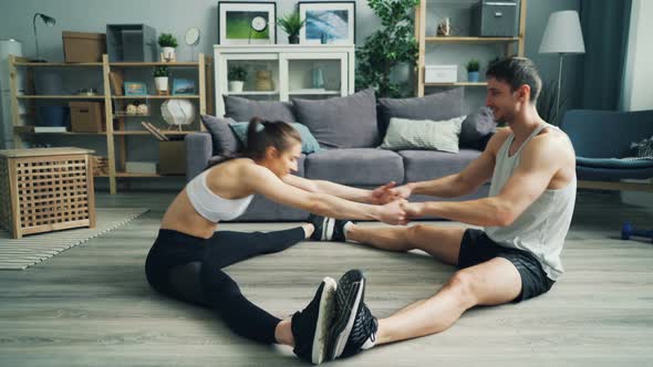 Man and Woman Stretching Then Doing High-five Talking and Showing Thumbs-up