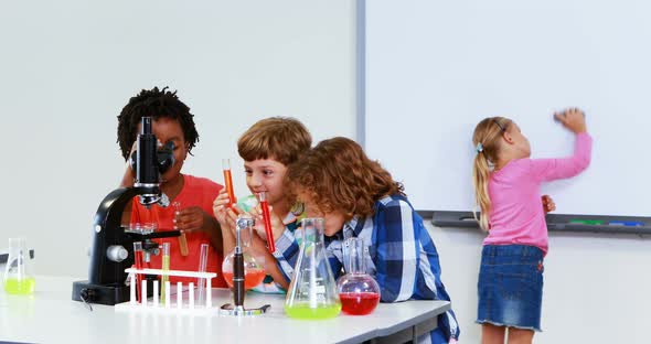 Kids doing a chemical experiment in laboratory