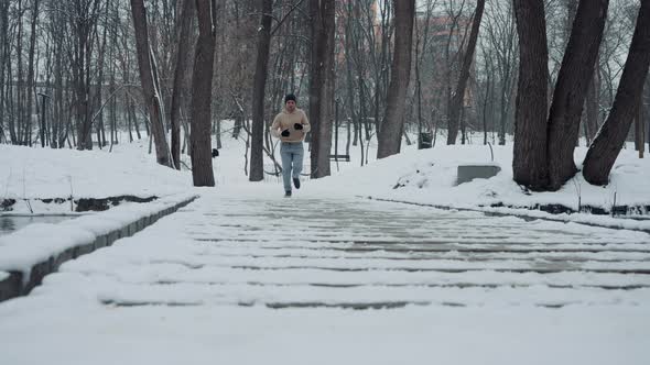 Man Jogging on Bridge in Winter Park