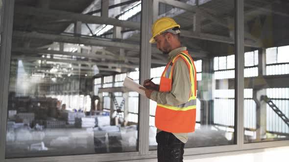 Construction Site Manager in Reflective Vest Making Notes