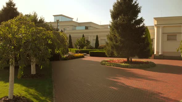 Mansion and Yard with Cobblestone Floor Trees and Bushes