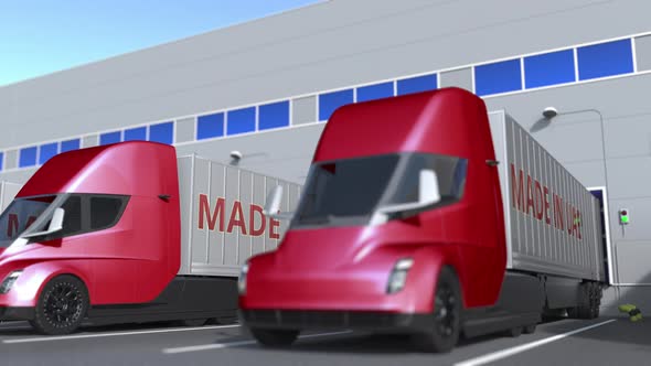 Semi-trailer Trucks with MADE IN UAE Text at Warehouse