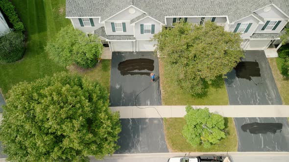 Aerial View of Driveway Sealcoating Pavement Near Private Houses in the Suburbs