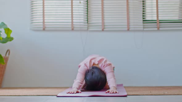Side view of Asian woman in casual doing Yoga exercise,Yoga Child pose