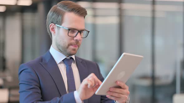 Portrait of Businessman using Digital Tablet