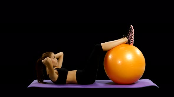 Woman in Gym Outfit Excercising with a Pilates Ball, Alpha Channel, Matte
