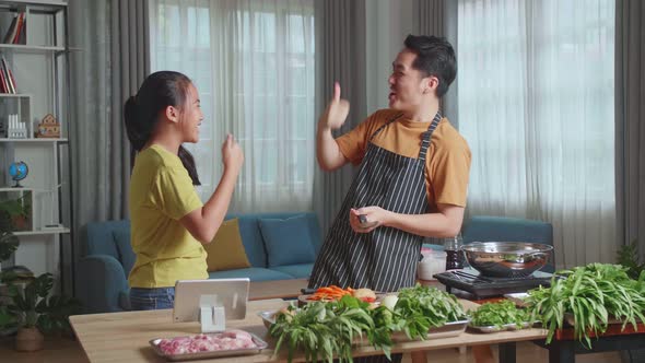 Asian Man Father And Daughter Cooking At Home, Food Tasting, Thumbs Up And Giving High Five