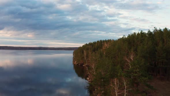 Aerial View of the Natural Landscape Forest on the Lake Shore at Sunset