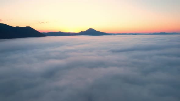 4K Sun is rising above sea of clouds until the horizon