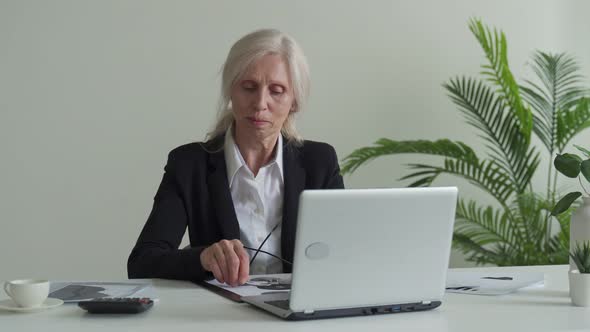 Tired Frustrated Grayhaired Woman Takes Off Glasses Feeling Eye Strain From Computer