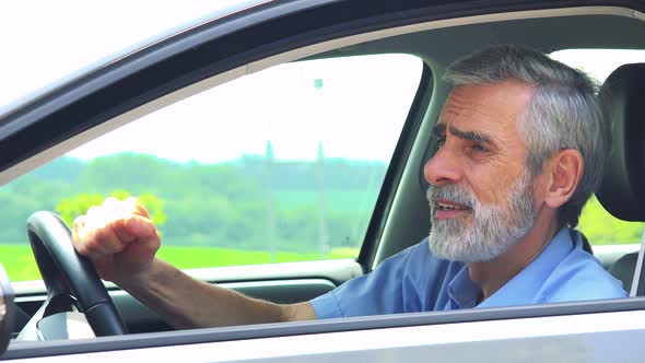 Senior Man Sits in the Car and Has Depression - Closeup Shot From Side - Countryside