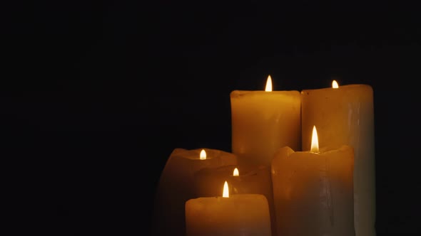 Burning Wax Candles on Black Chroma Key Background