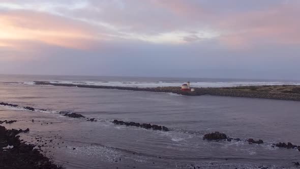 Coquille River lighthouse drone footage taken during sunset, where Pacific Ocean meets the Oregon co