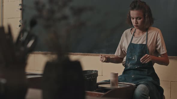 Artist Making Jar on Pottery Wheel