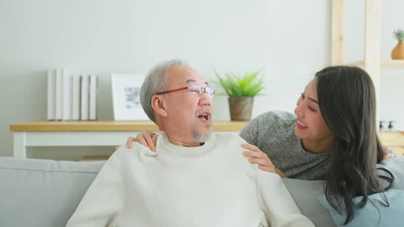 Asian lovely family, young daughter greeting and hugging older father.