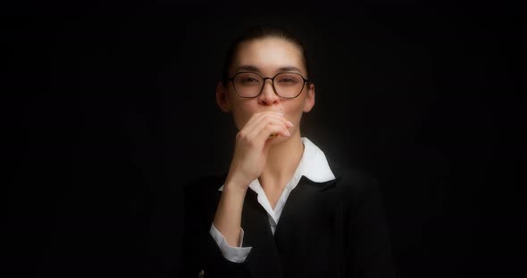 Positive Businesswoman Smokes an Electronic Cigarette