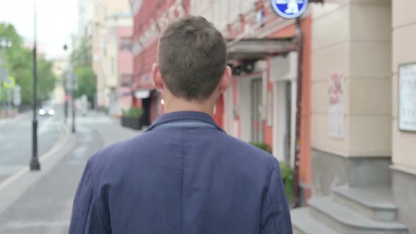 Close Up of Mature Adult Man Walking in a Street Back View