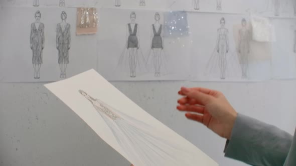 Pretty Girl Fashion Designer Drawing Clothes on Paper Creating New Collection