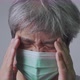 Sick Asian man wearing a medical face mask and Take a hand to hold the headache - VideoHive Item for Sale