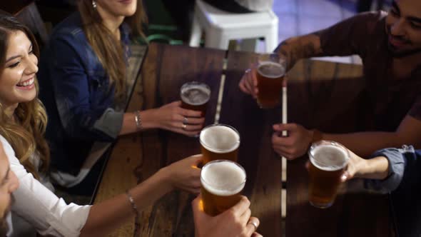 Friends cheers with beer at a bar in Patagonia Argentina