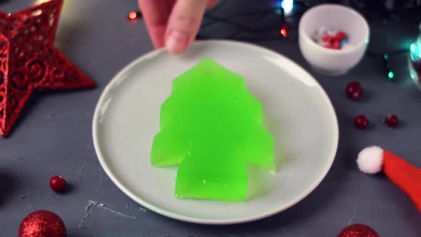 Christmas tree jelly is wiggling on the ceramic plate