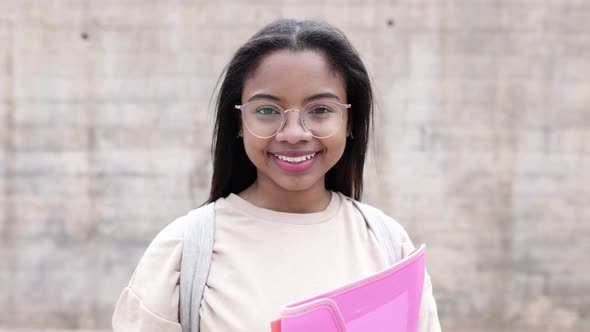 Portrait of Smiling Young Hispanic Latina Student Girl Looking at Camera