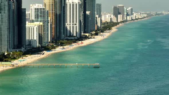 Aerial video Sunny Isles Beach fishing pier. 4k 7x zoom aerial drone clip