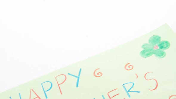 Color pencil kept on happy mothers day greetings card