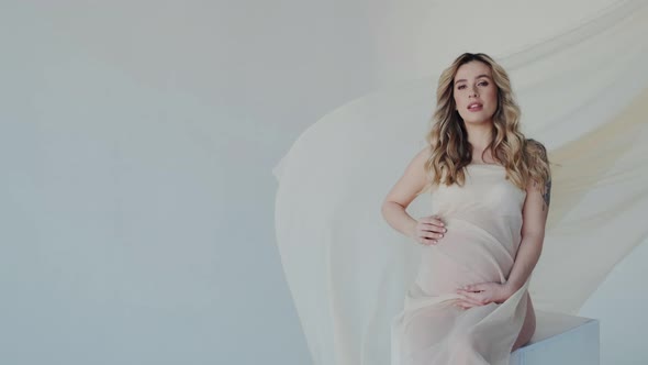 Gorgeous Voluptuous Pregnant Woman Posing on Camera in Fashion Studio